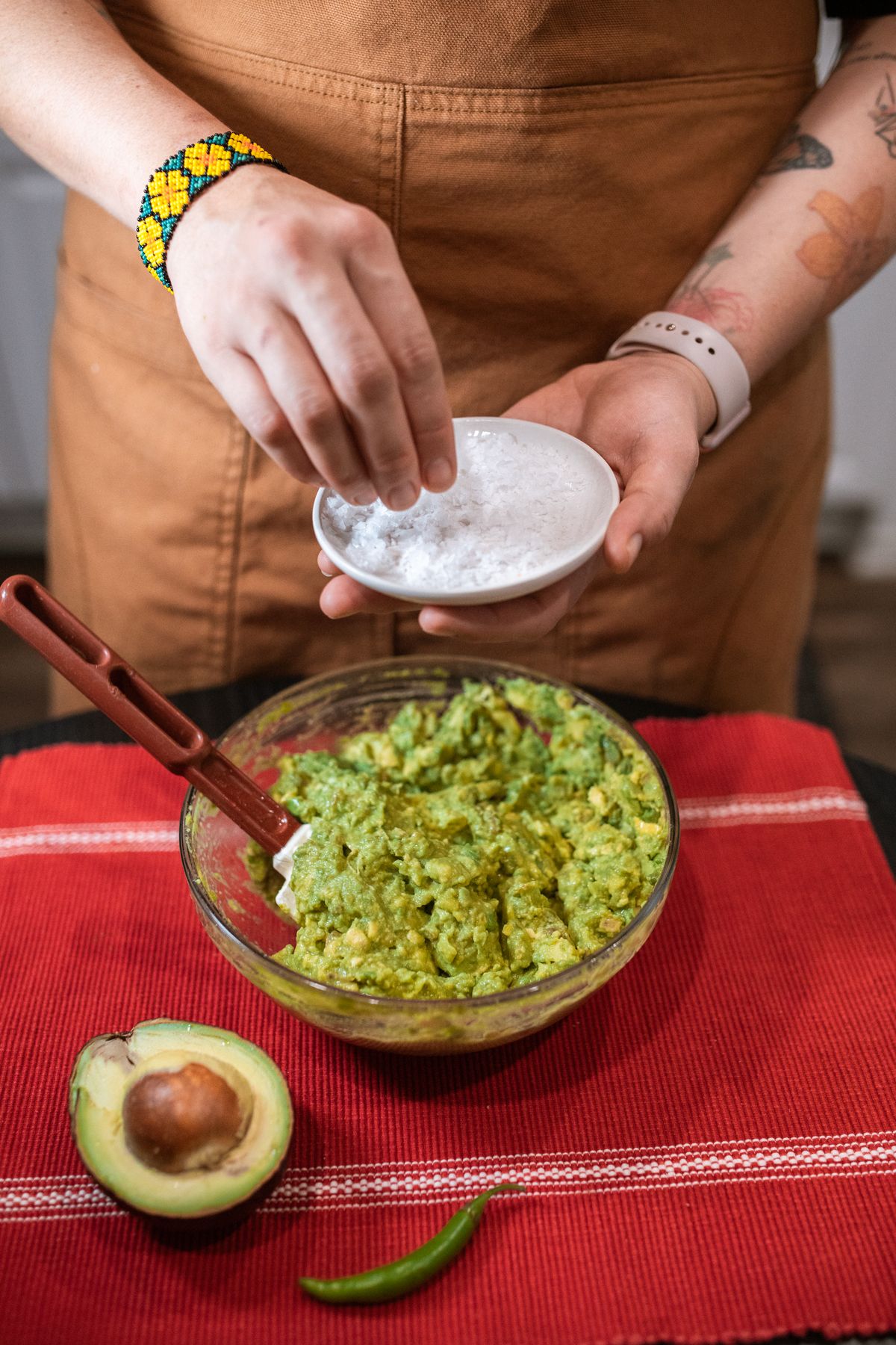 A person mashing avocado to make guacamole by hand