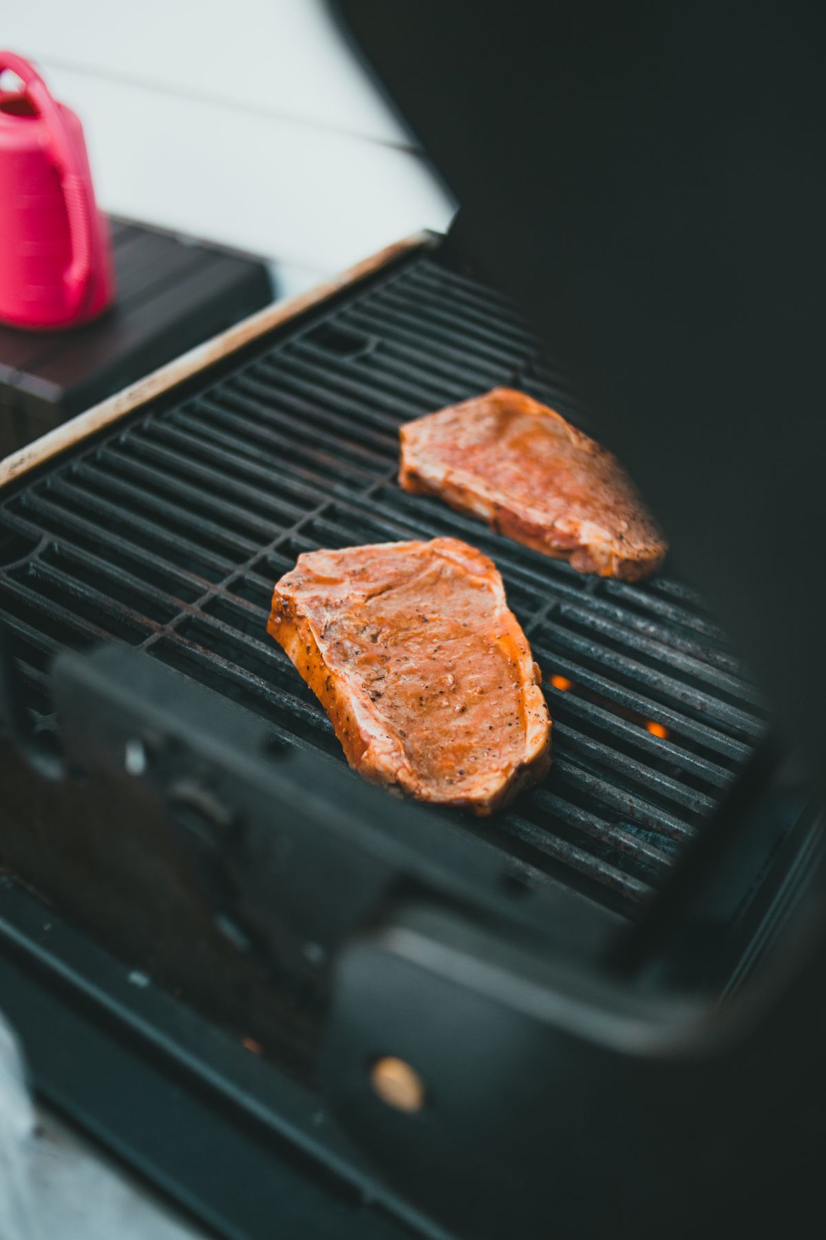 A steak searing on a hot grill, close up