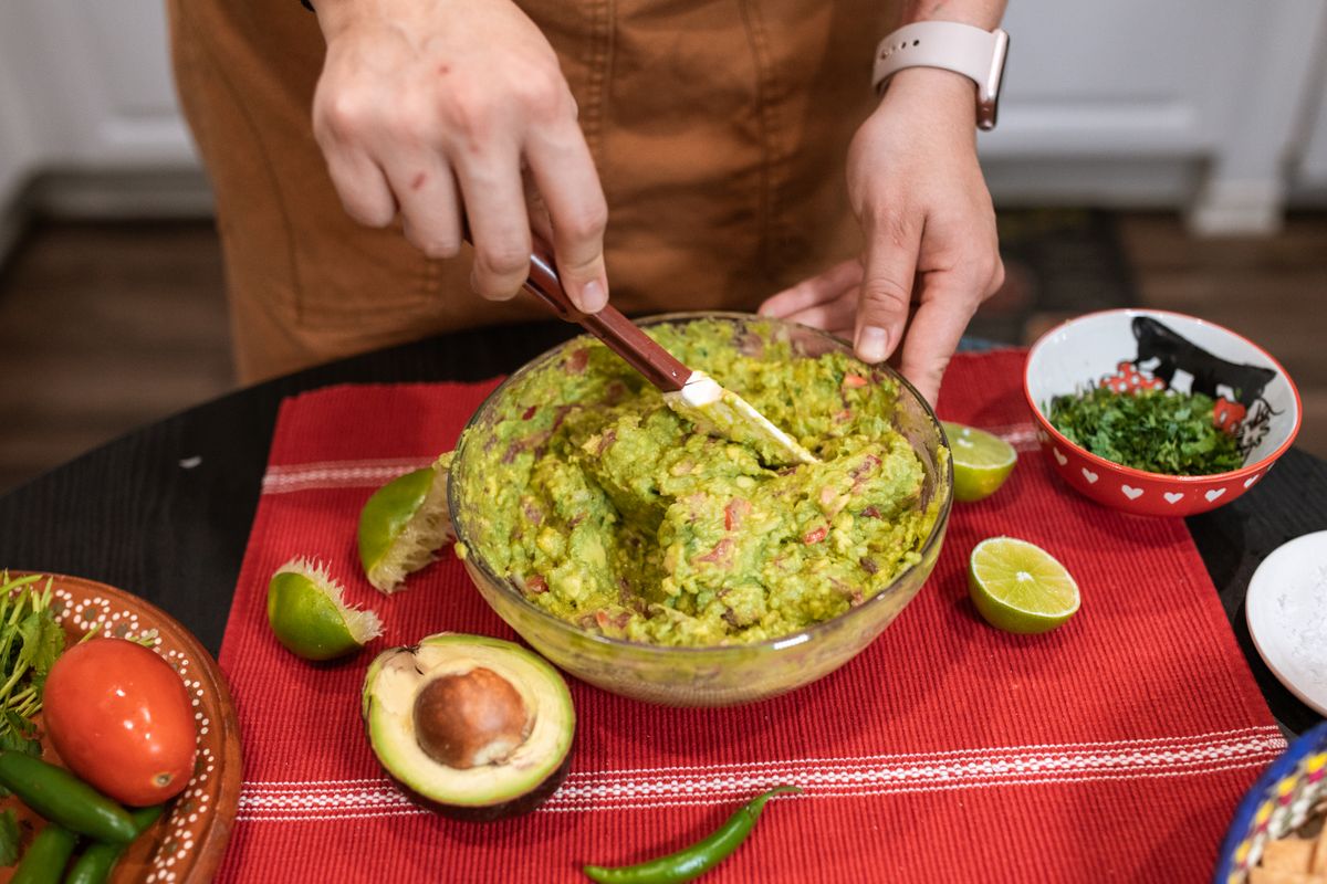Green guacamole in a clear glass bowl