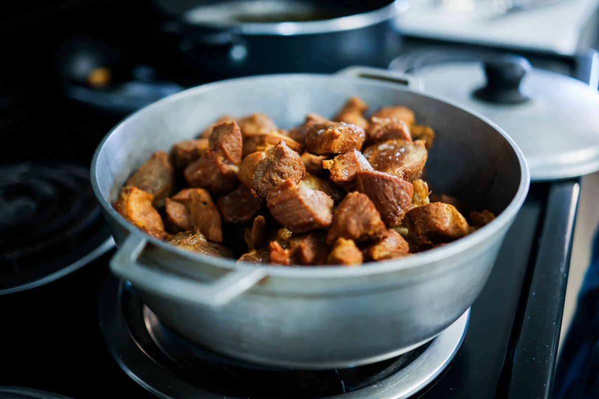 Chunks of tender slow-cooked meat in a large pot